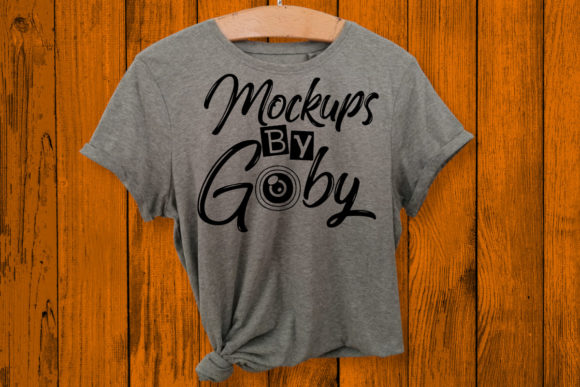 Gray Shirt, Bold Backdrop: A Designer’s Take on the Hanging Gray Shirt Mock Up, Orange Backg
